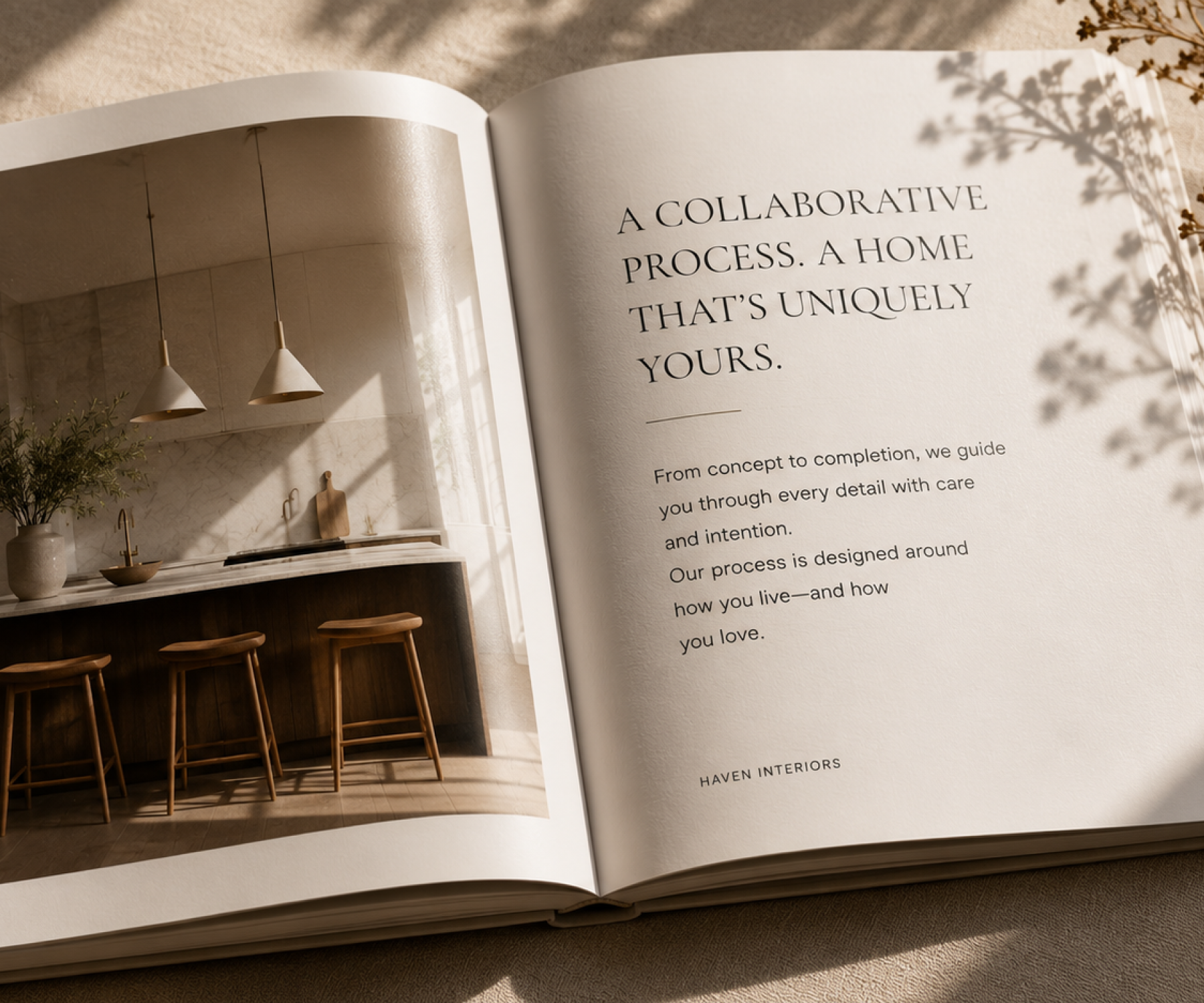Open book showing a kitchen with wooden stools and text about a home design process by Haven Interiors.