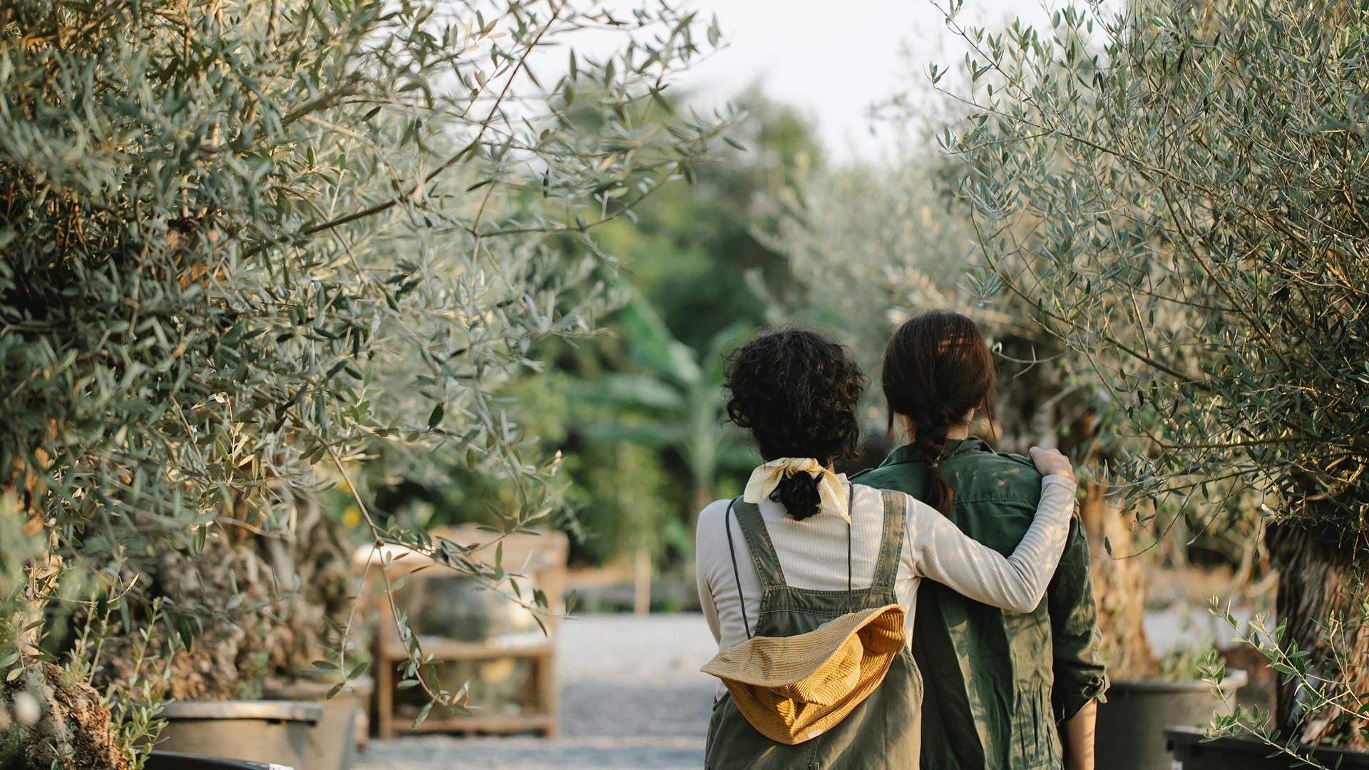 Two friends walking down a garden path.