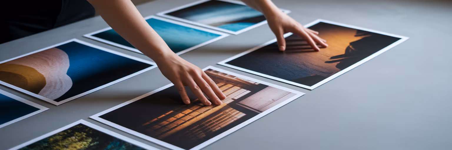 Designer arranging photos for a visual moodboard.