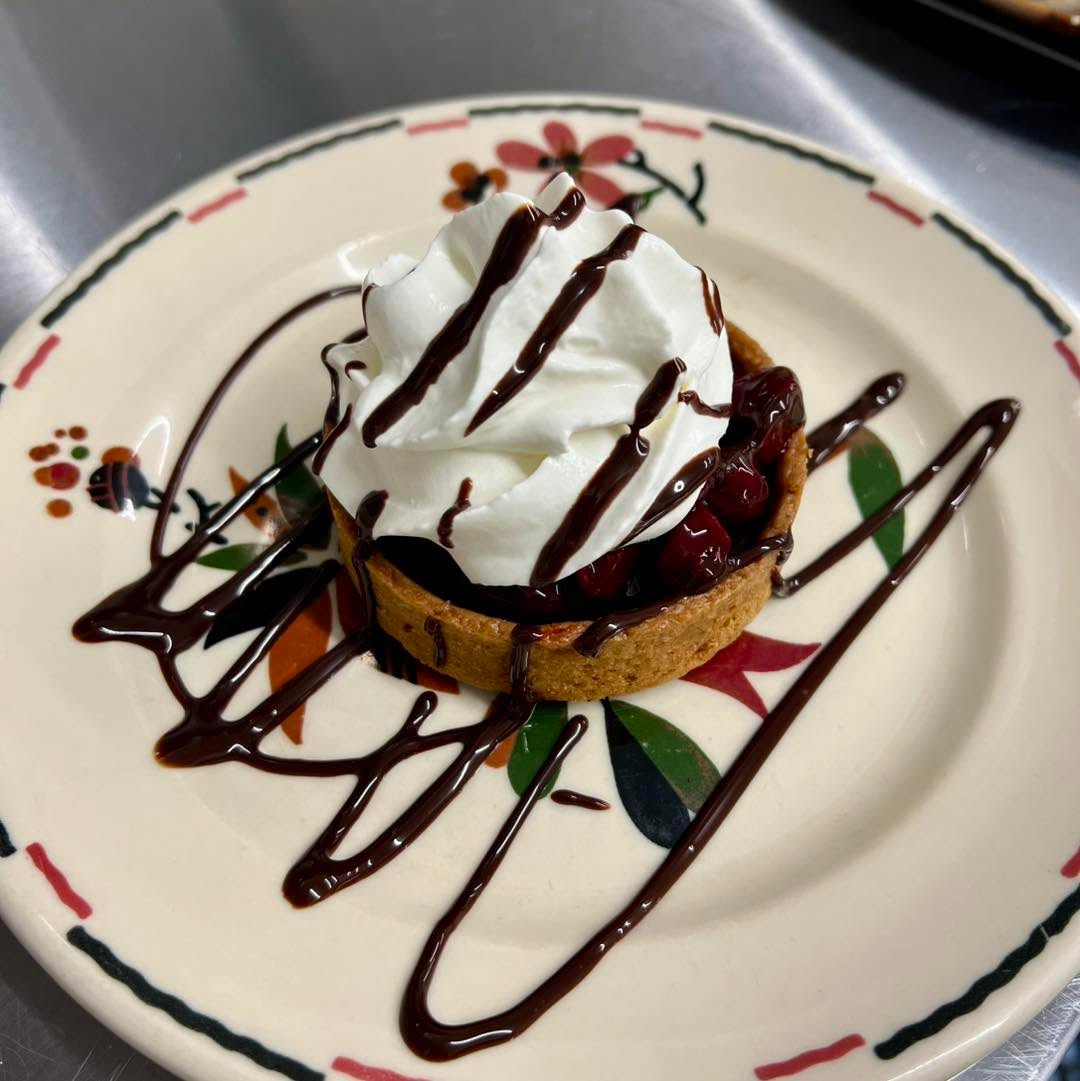 Our fall Black Forest Tart, with a chocolate ganache filling, Morello cherry compote, and (also homemade) whipped cream. 😋

Come try it for brunch or dinner this fall!