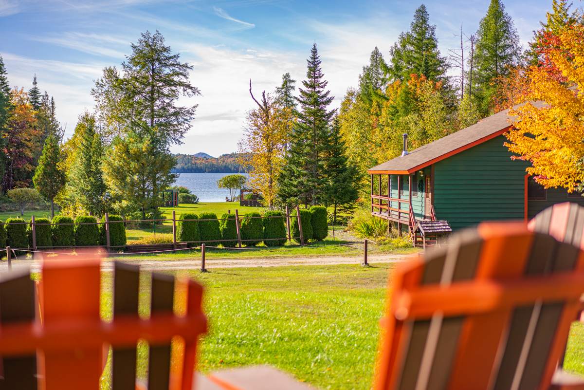 Adirondack Chairs with a peak fall foliage view of Lake Clear.