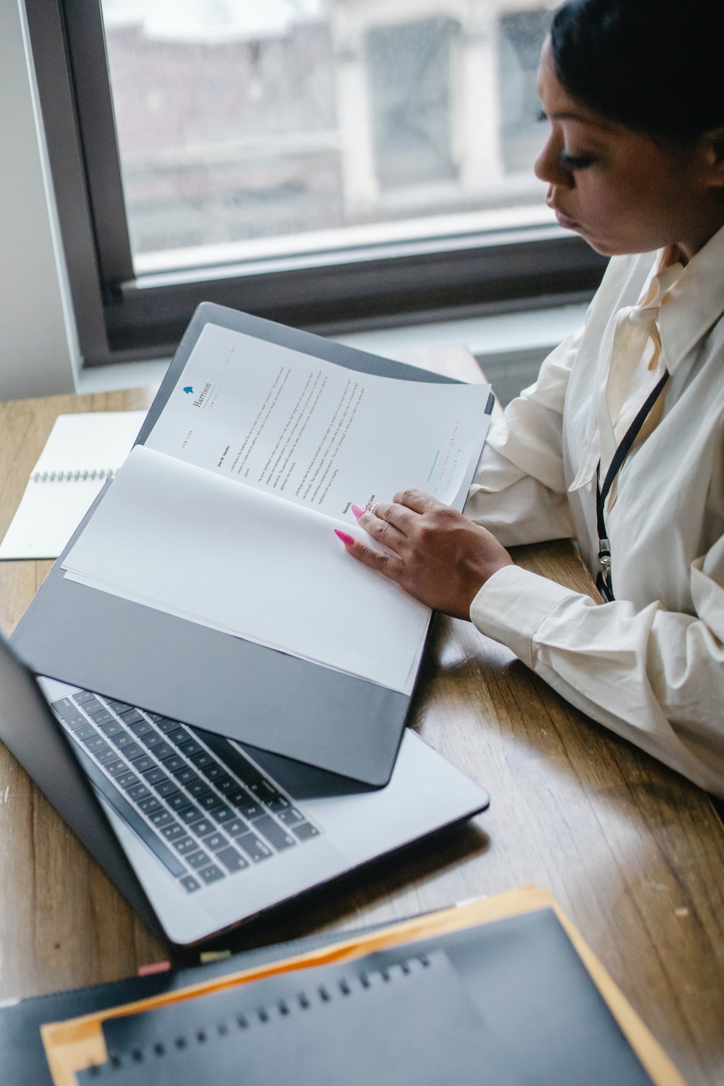 A person reviewing a printed document in a folder