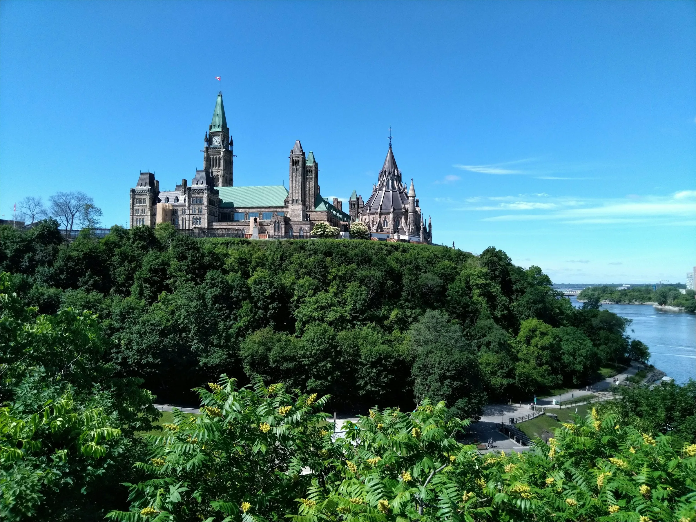 Parliament Hill in Ottawa seen from across the Ottawa River on a clear summer day