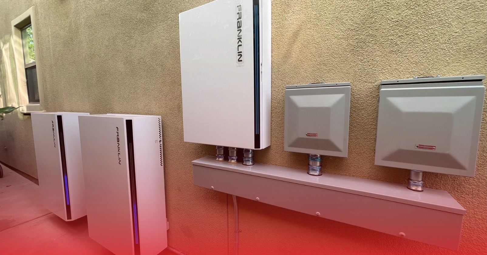 Battery backup energy storage system installed on the side of a stucco home