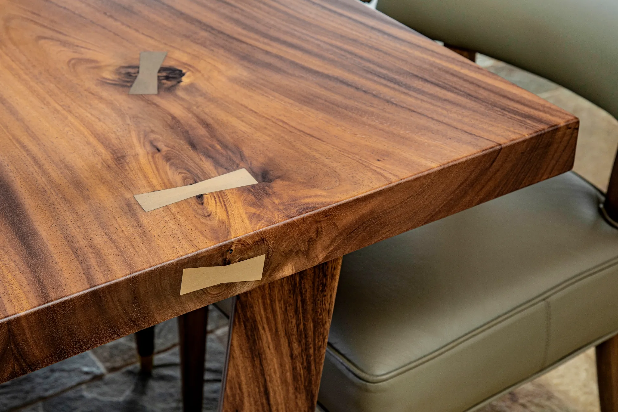 Close-up of a custom wooden table with brass inlay at Maui Island Retreat