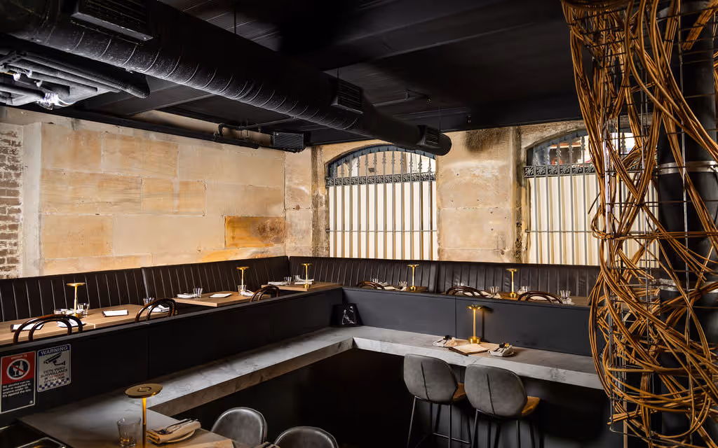 Panoramic shot of long booth seating and high ceilings in Hustlers Sydney, demonstrating venue capacity for corporate dinners.