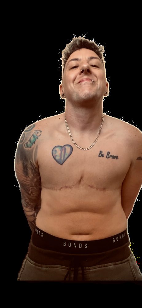 Ty Aster shirtless and smiling with their head tilted back, showing tattoos and a silver chain, against a white background.