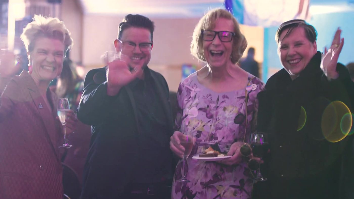 A group of guests waving at the camera at the 2025 Gala