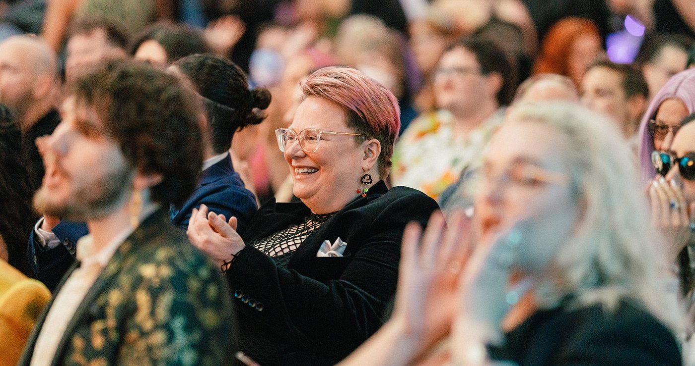 Guests in the audience clapping and cheering