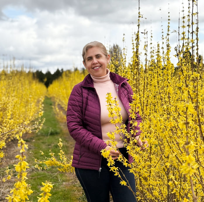 Ramony Arcadia outdoors in a field of yellow blooms.