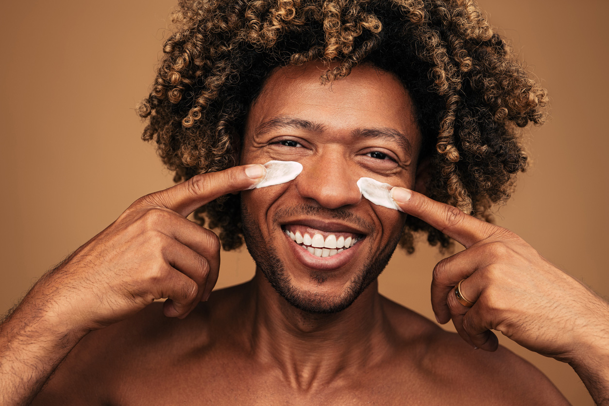 A man puts on his daily sunscreen for protection.