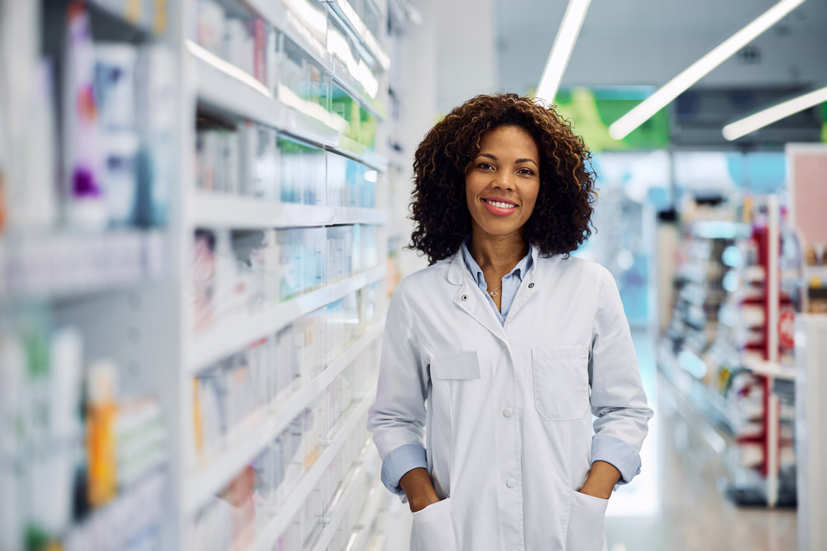 A local pharmacist stands in her pharmacy. 