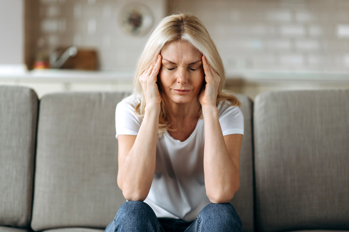 A woman suffers from head pain. 