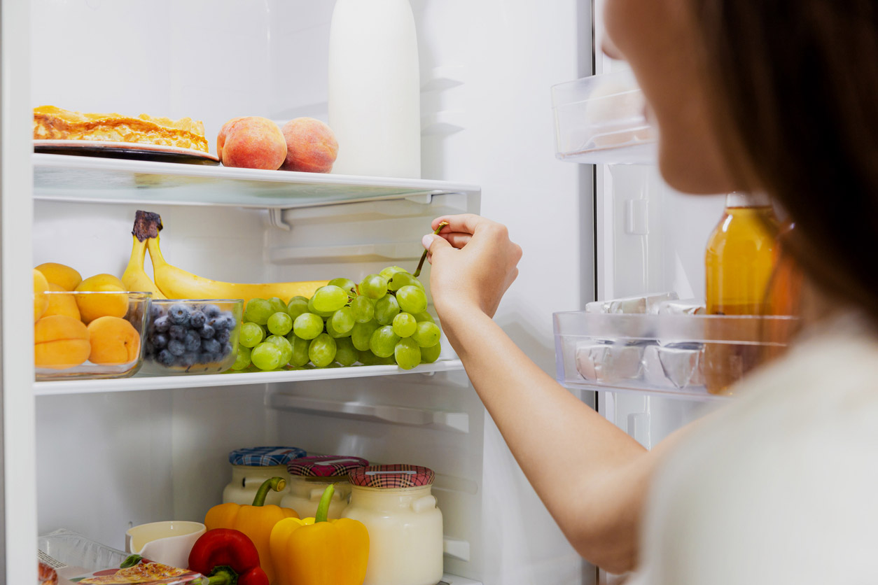 A patient on a GLP-1 searches for a healthy meal option in their refrigerator.