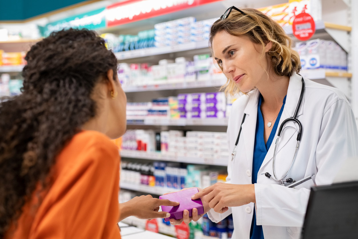 A pharmacist conducts an in-depth, personal consultation with a patient. 