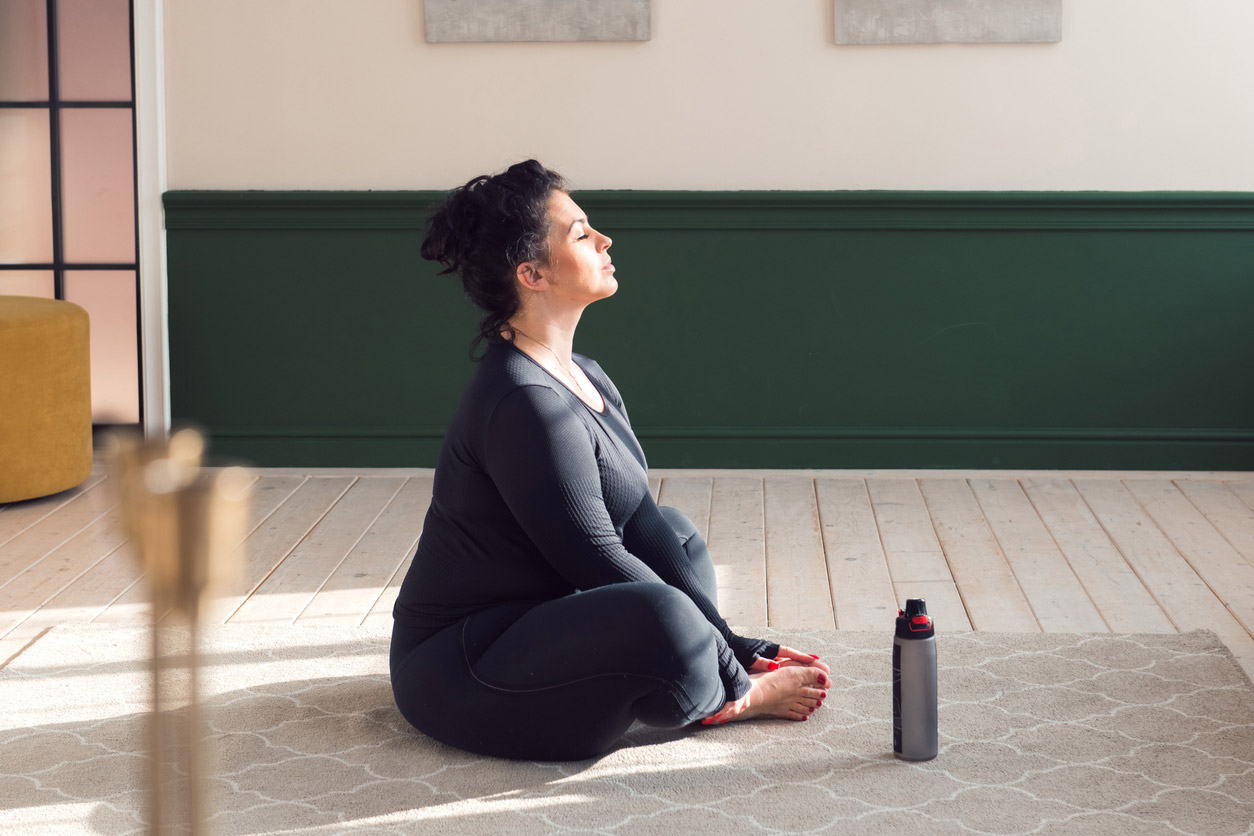 A woman on a GLP-1 medication uses meditation to keep her stress levels manageable.
