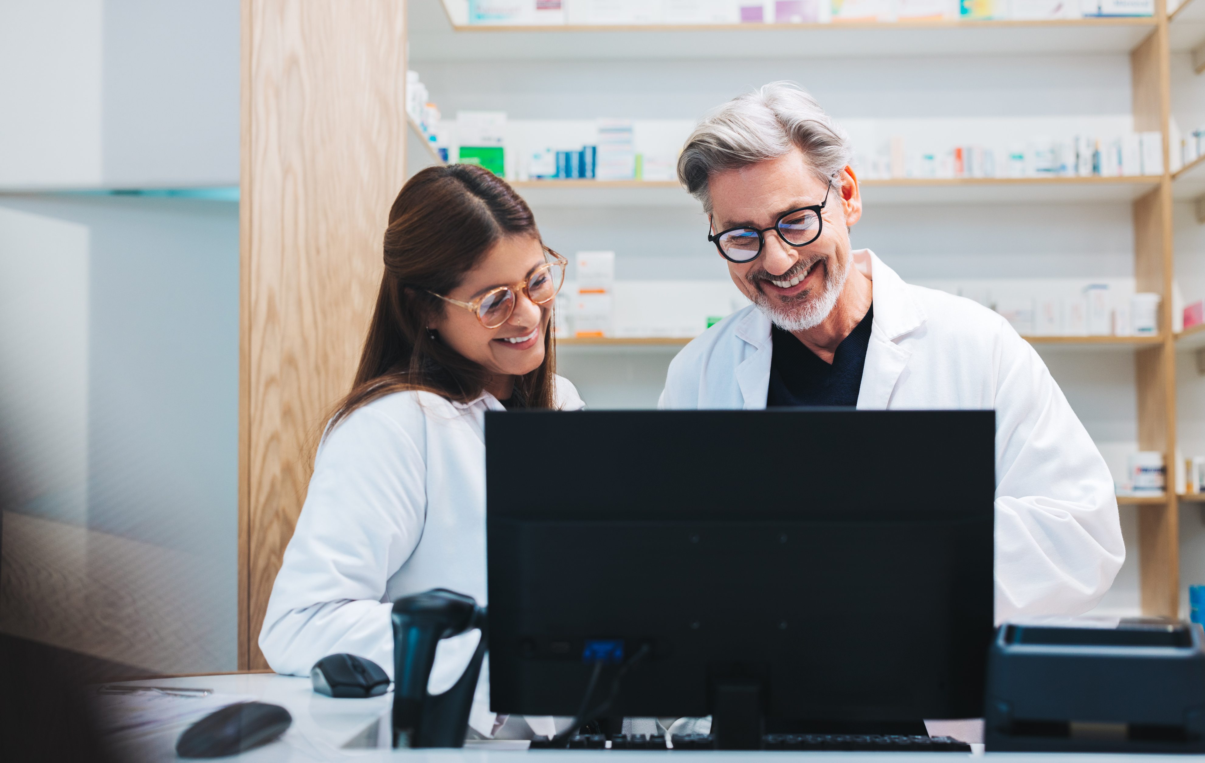 Pharmacists on a computer