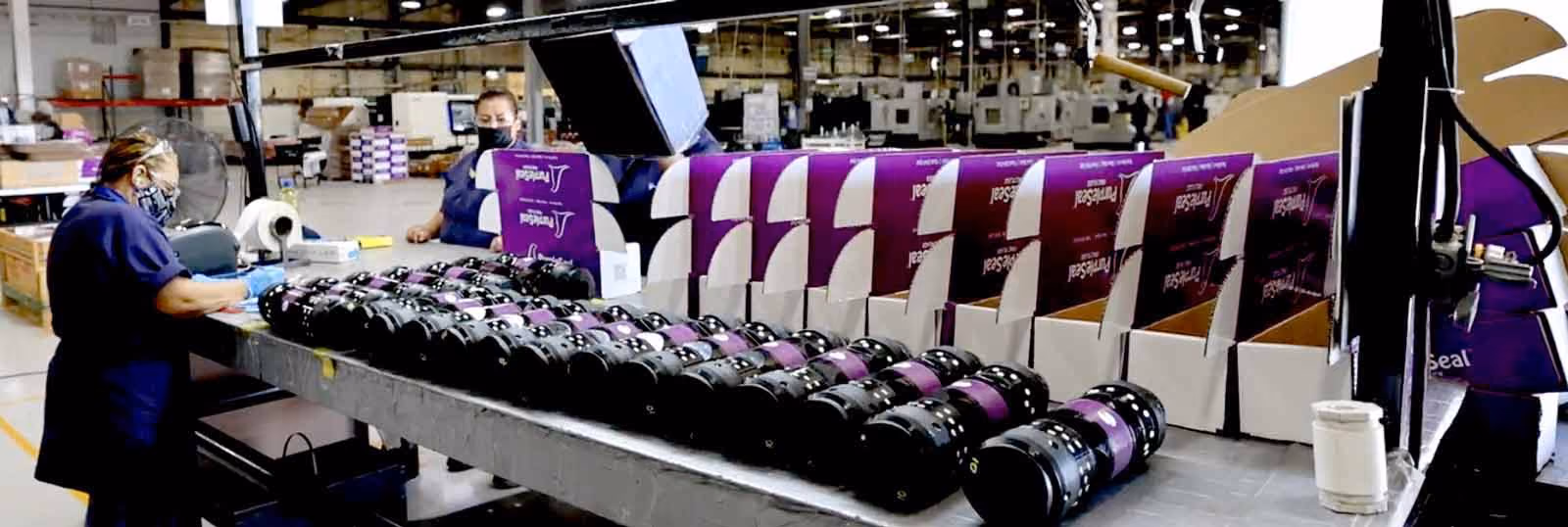 A line of PurpleSeal Frac Plugs on an assembly line ready to be boxed.
