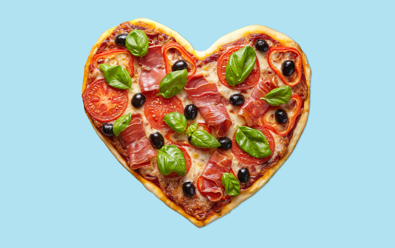 An image of a pizza shaped like a heart