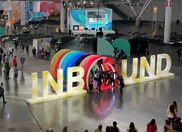 A shot from high above the expo floor at Hubspot Inbound. In the center of the photo is a large inbound sign