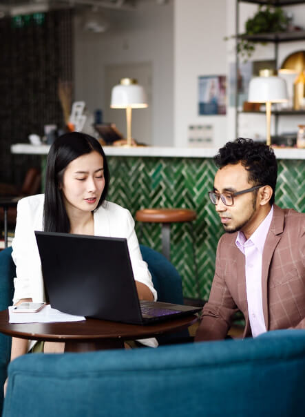 Woman and man sitting behind a computer.