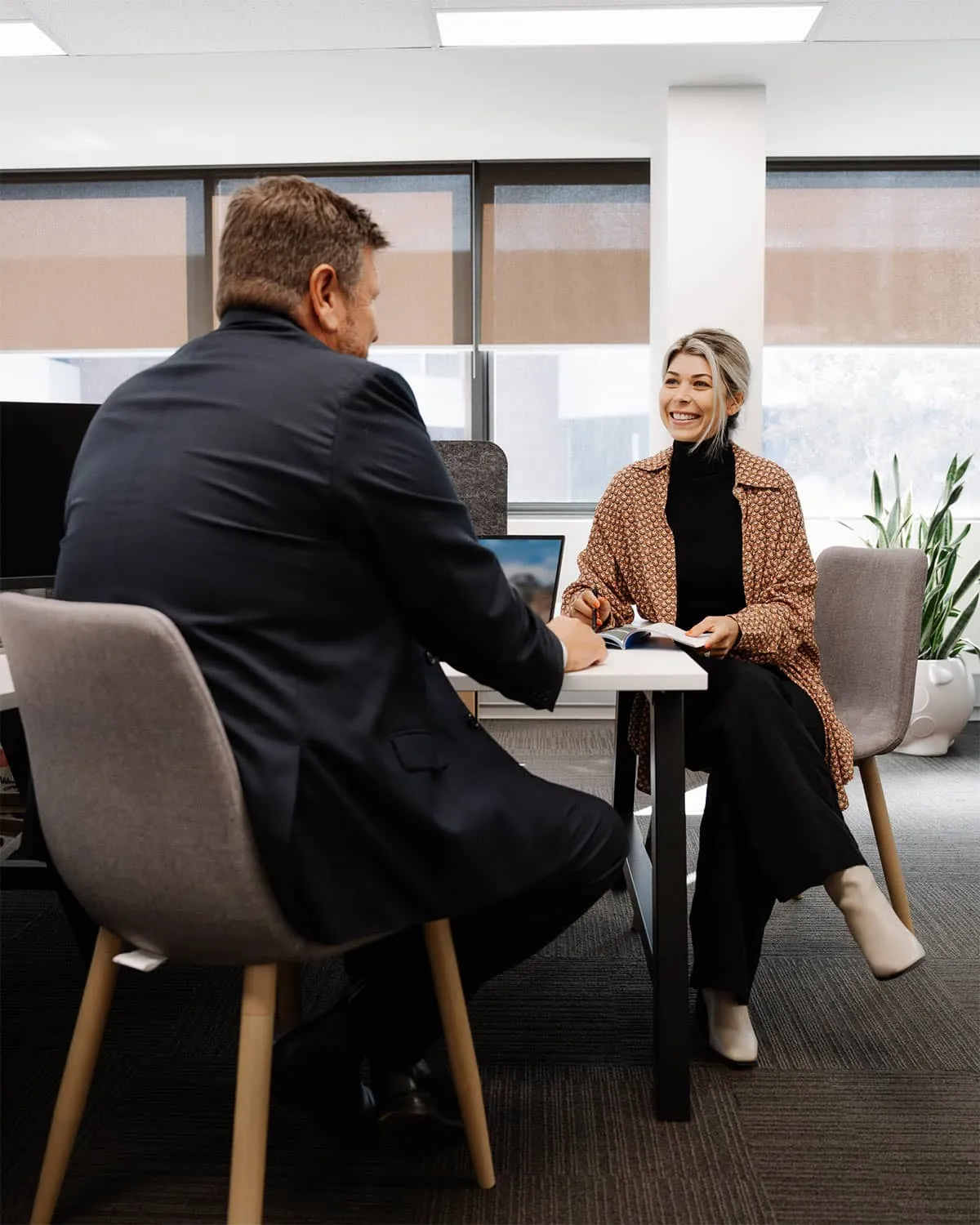 Professional Fuse HR team members discussing strategic advice in their office