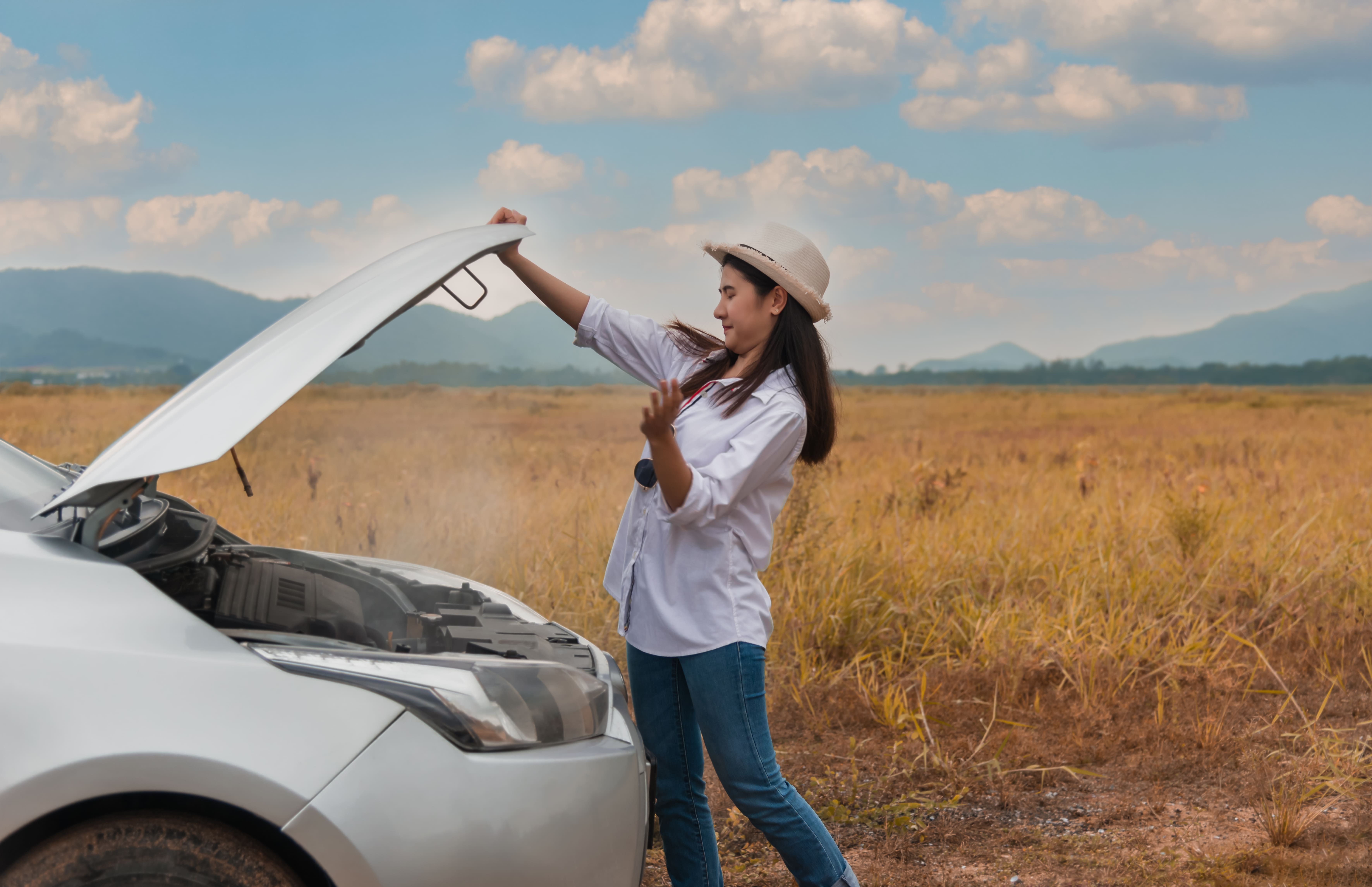 Woman opening car hood