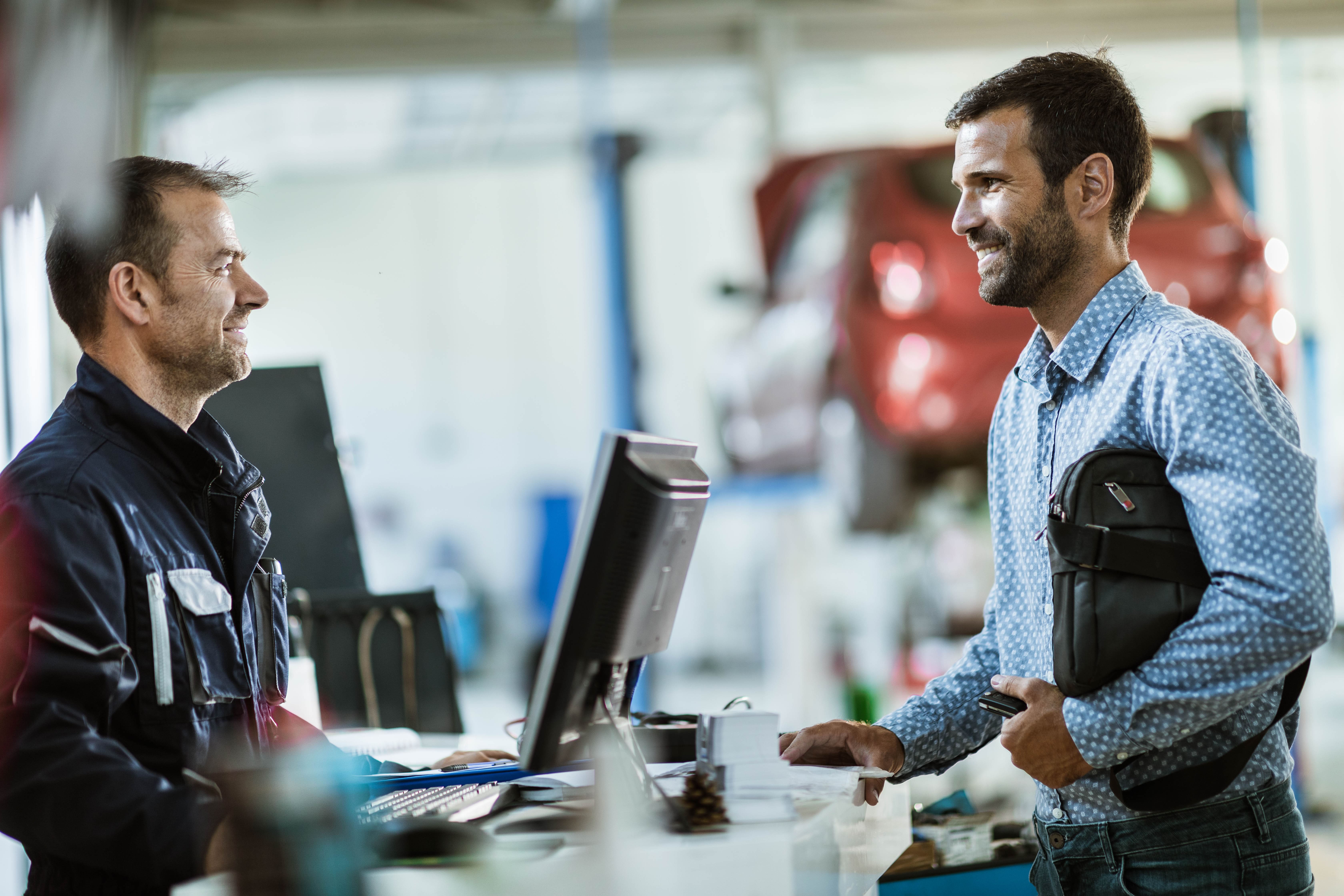 Men in a car workshop talking