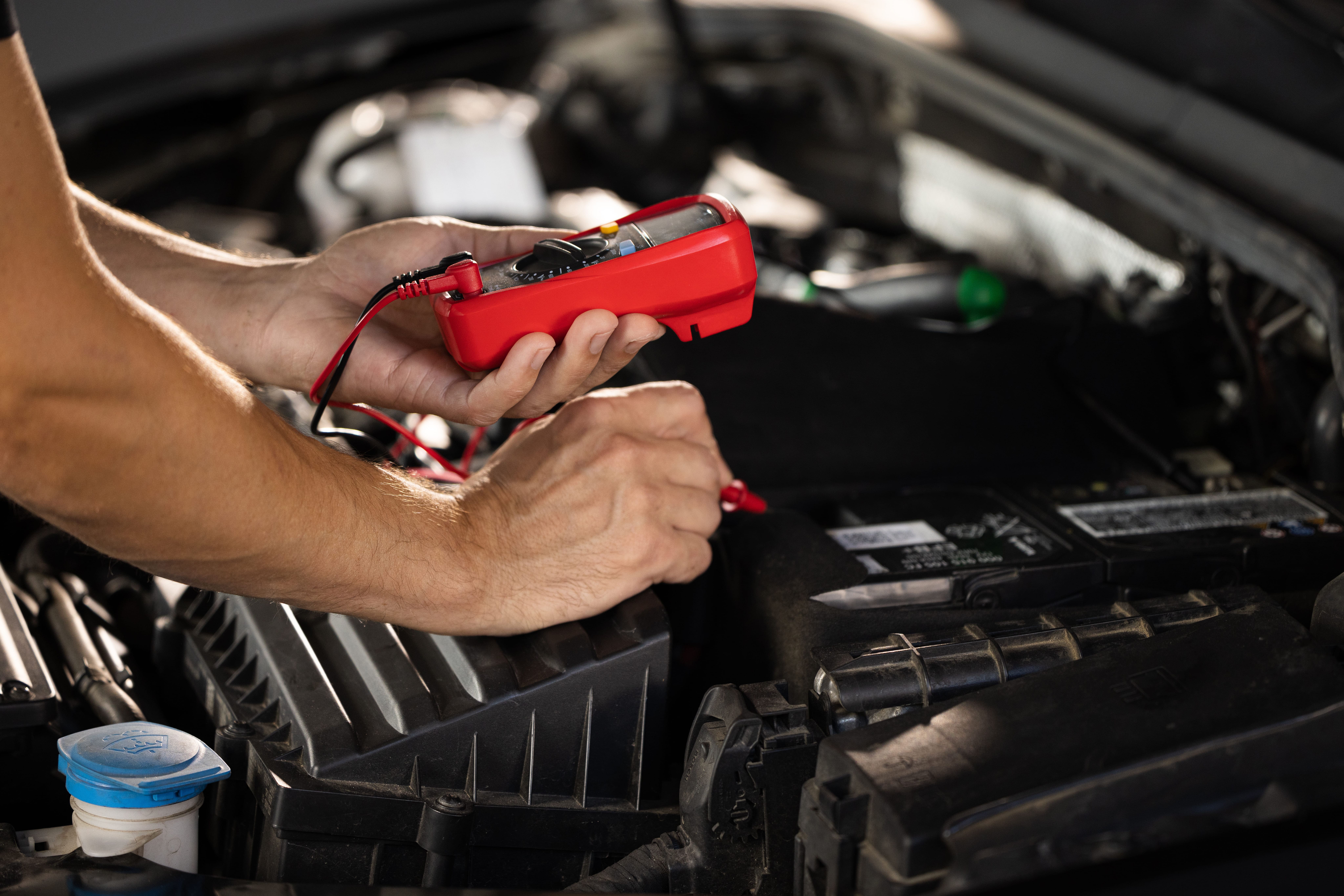 Man checking the car’s tire pressure