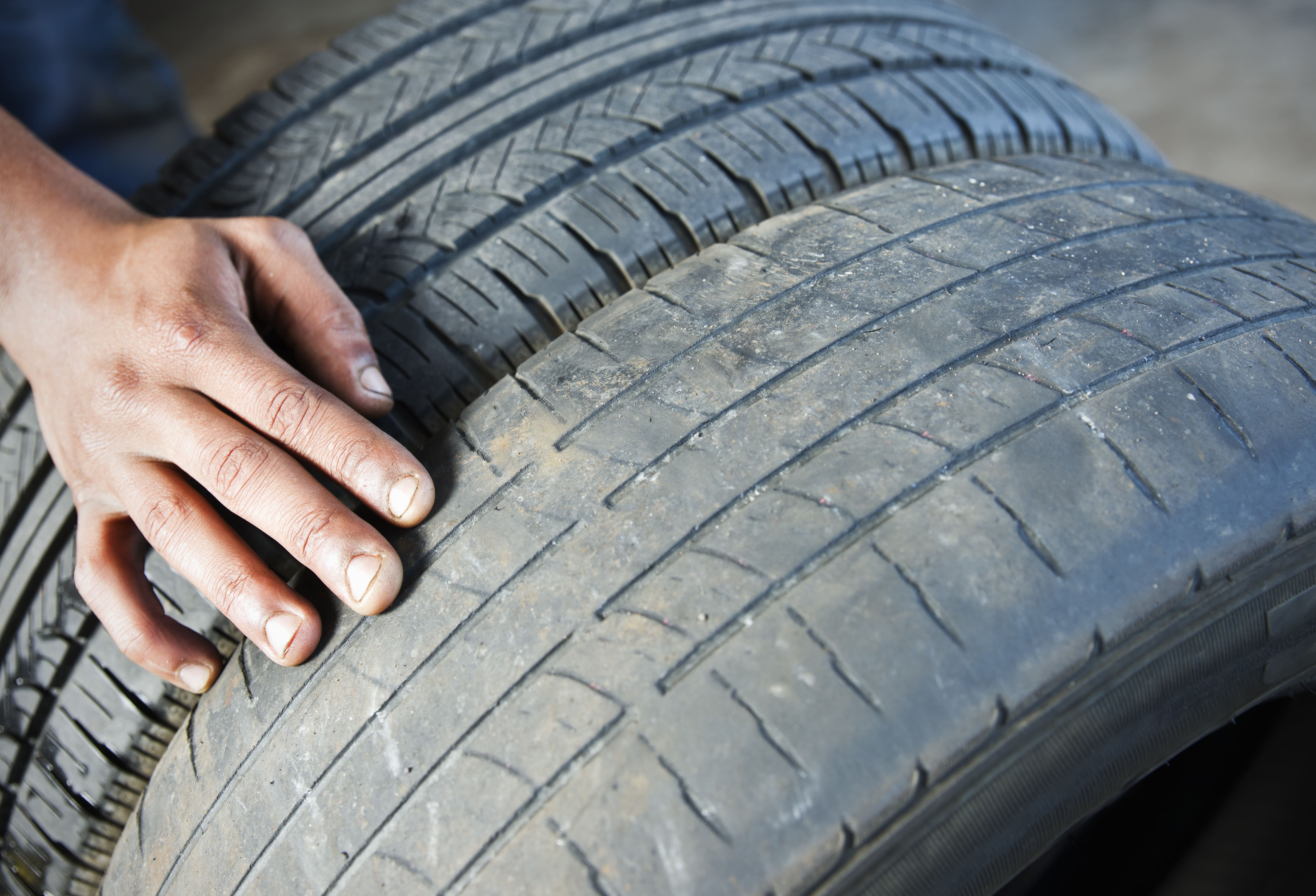 Man looking at tire
