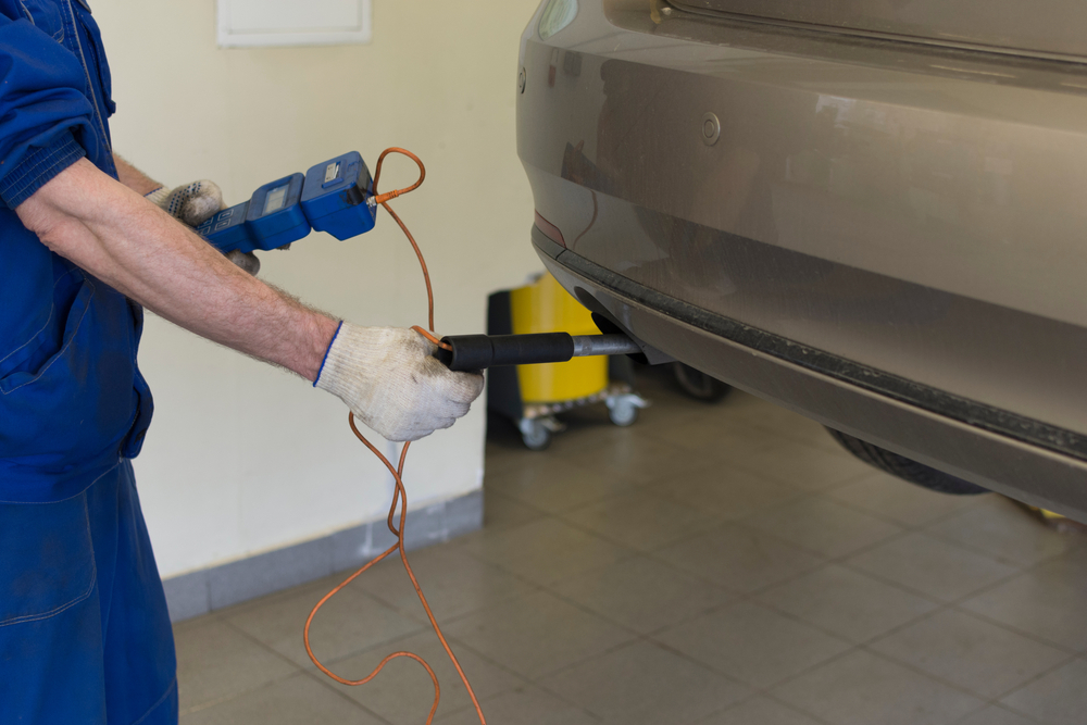 mechanic performing smog check