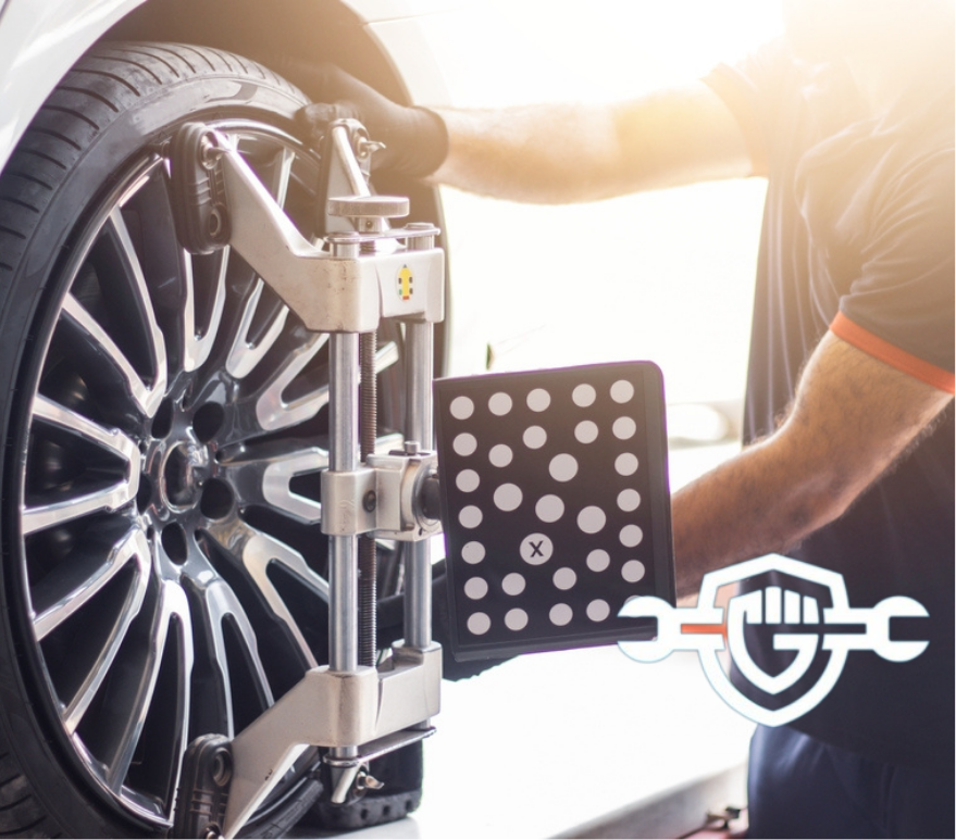 Vehicle wheel alignment. Tire wheel alignment. Technician placing sensors to tires for Alignment. Electronic Wheel Balance. Tire alignment checking.