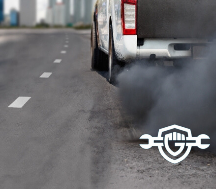 Black smoke coming out of an exhaust pipe.