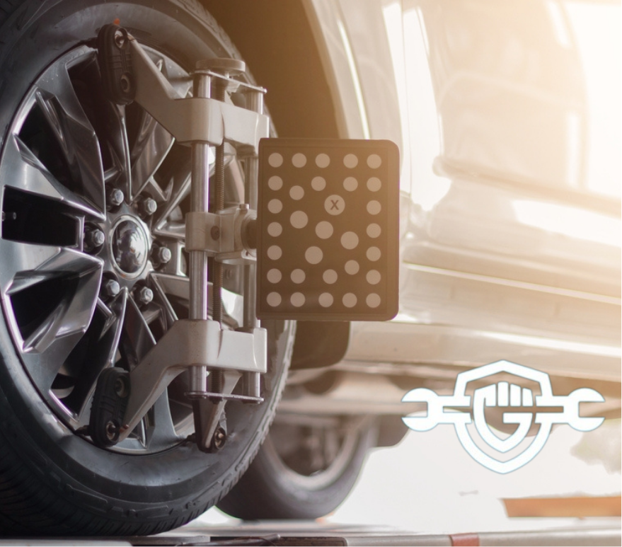 Computer alignment checking of a car in a worshop. Wheel balance checking at garage. Tire wheel balance measuring. Computer alignment sensor.