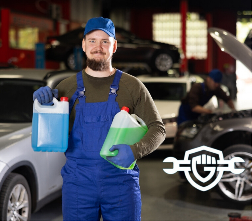 Mechanic holding two jugs of antifreeze for a vehicle