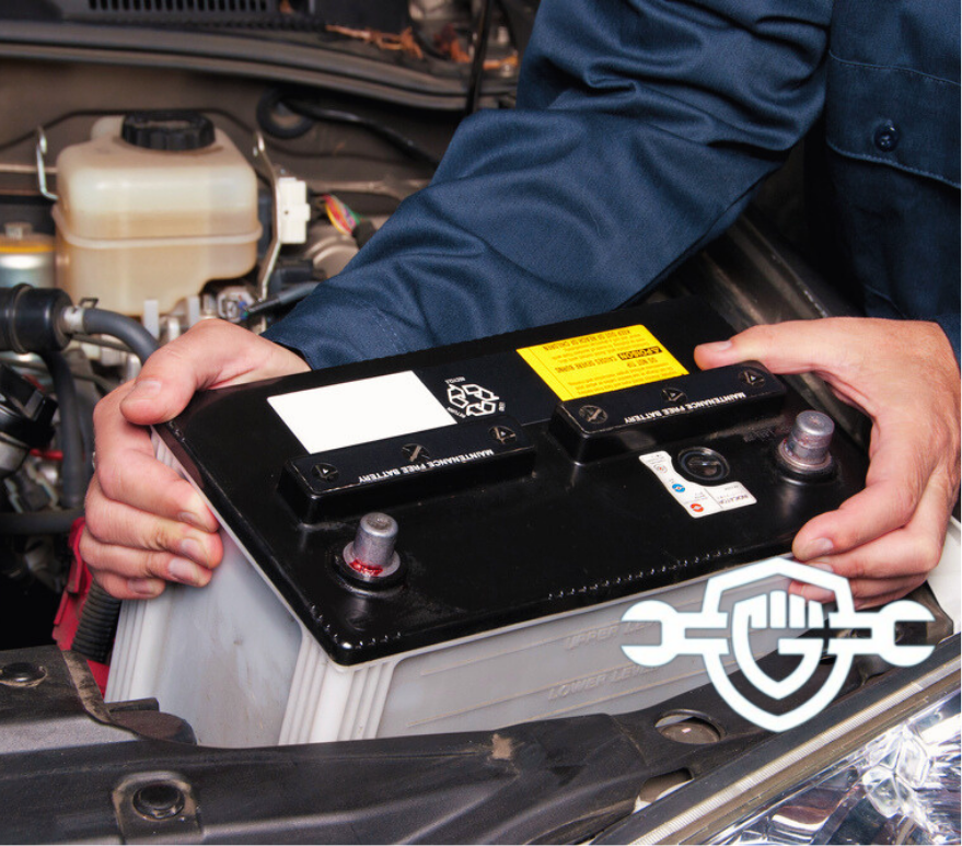 A car mechanic replaces a battery during maintenance.