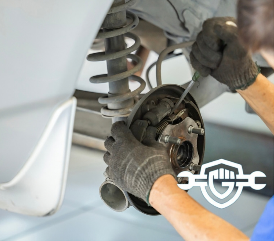 Close up image of mechanic examining a car wheel disc brake