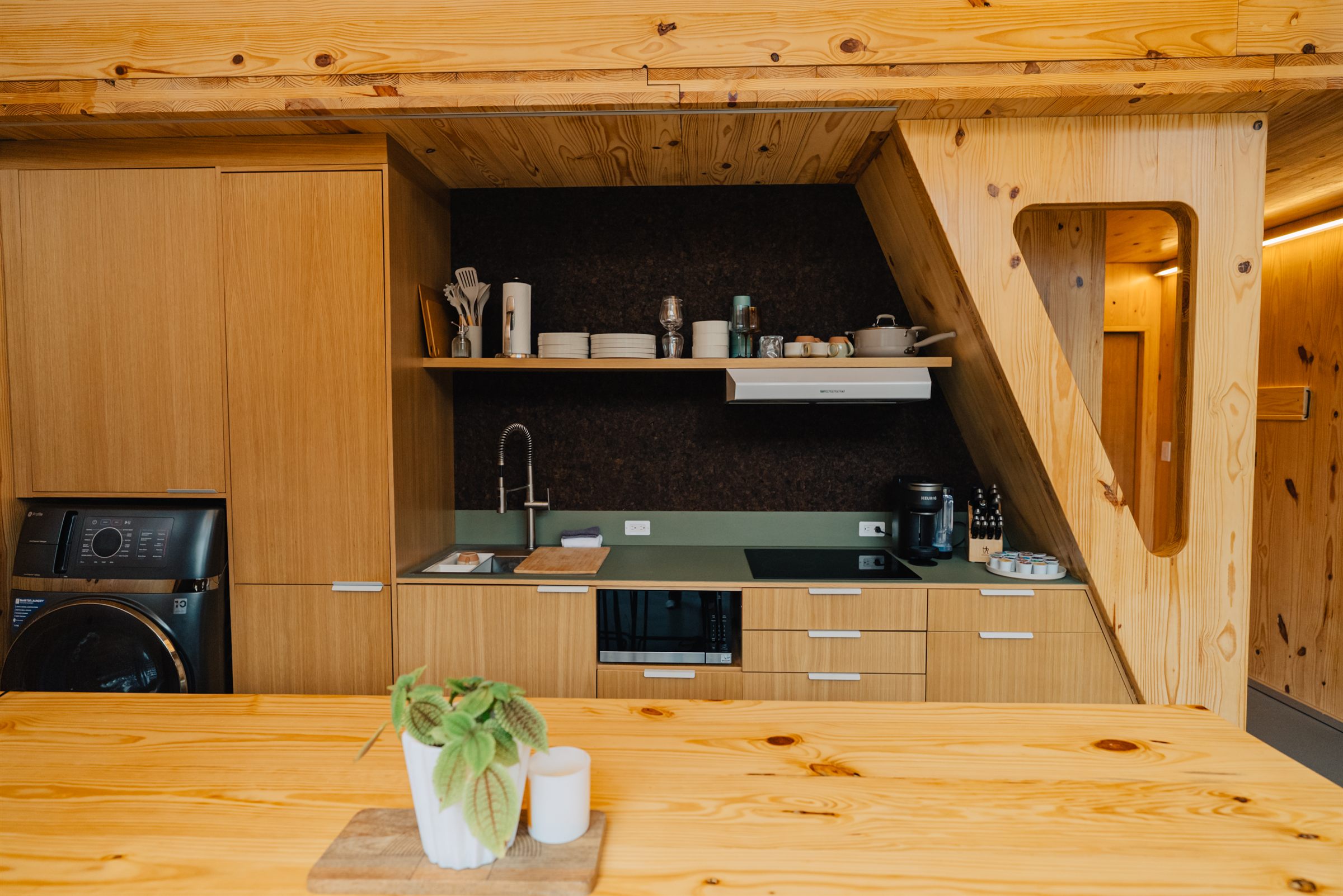 Waters Edge kitchen with minimalist cabinetry and wood tones