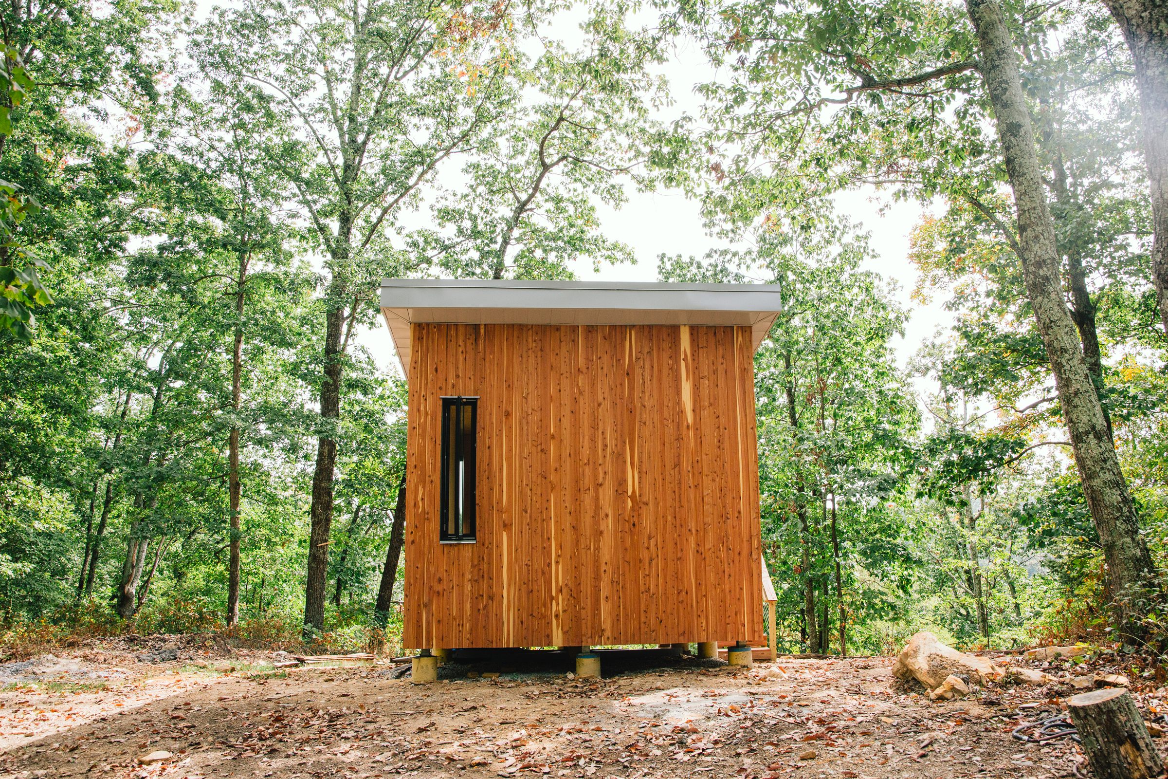 Cabin interior during construction with exposed framing and natural light