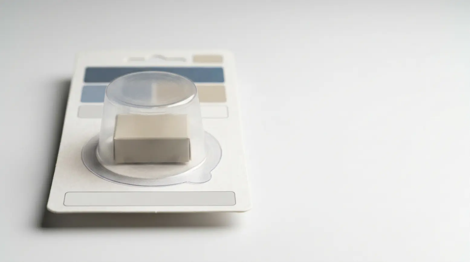 A clear blister pack with a simple product on a white background, showcasing minimalist packaging.