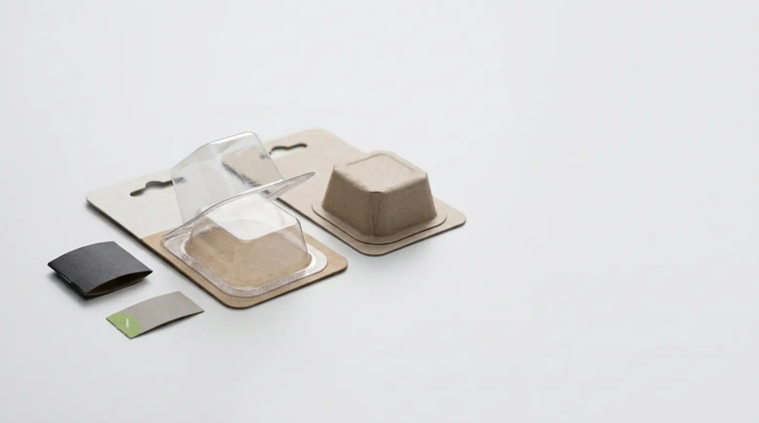 Clear PET blister pack alongside paper cup, showcasing recyclability and material comparison.
