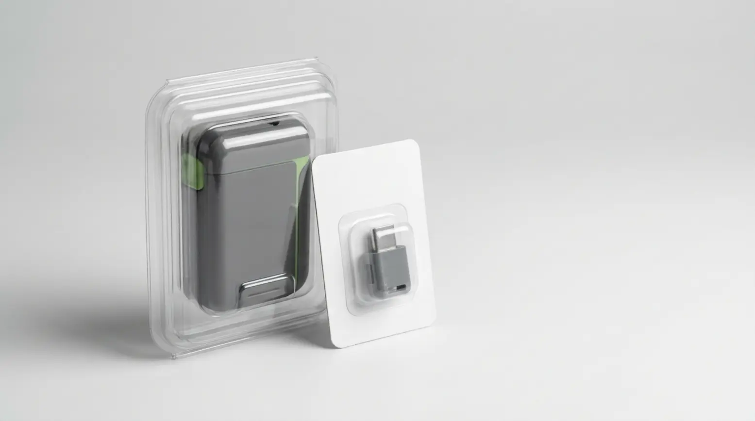 A clear PET clamshell pack with an electronics accessory and a carded blister, styled elegantly.