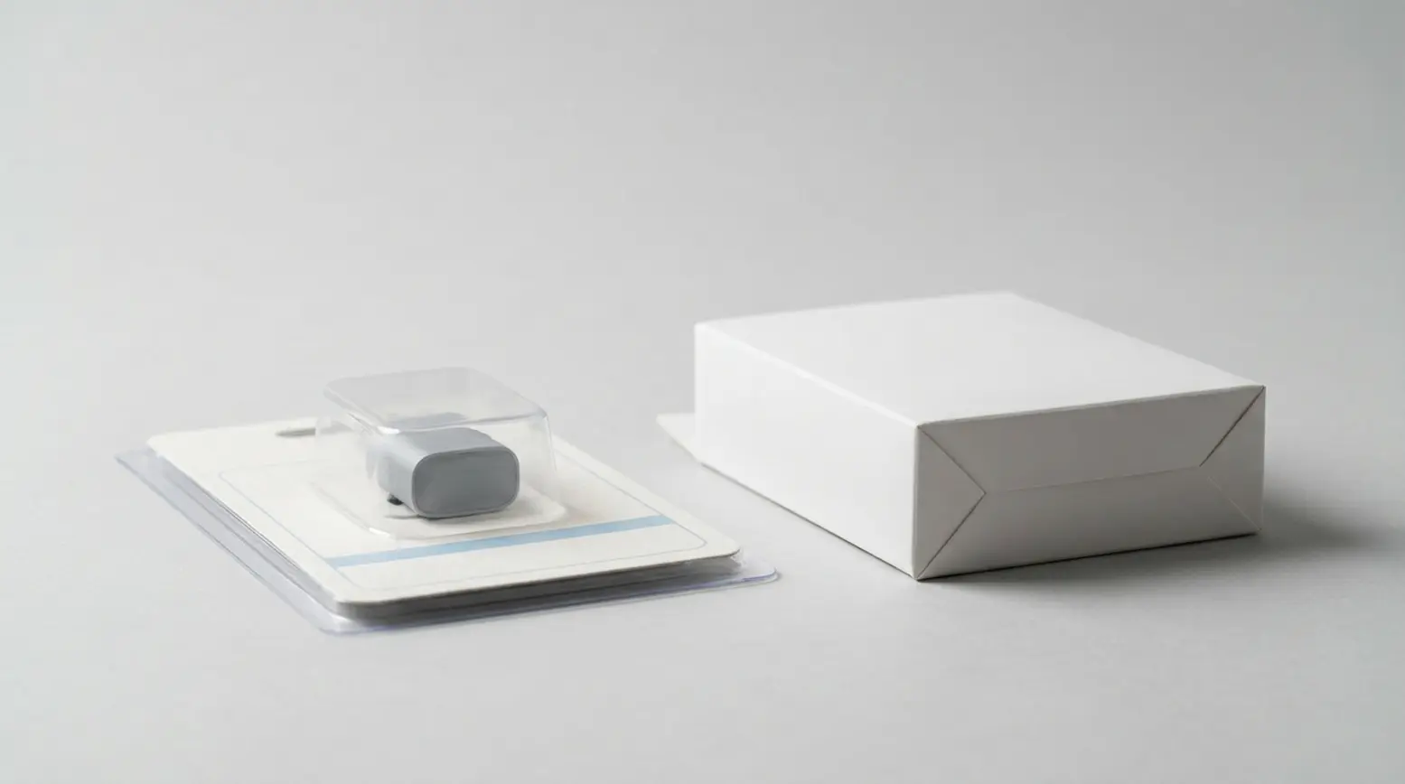 Premium product packaging showcasing a blister card and folding carton on a light grey surface.