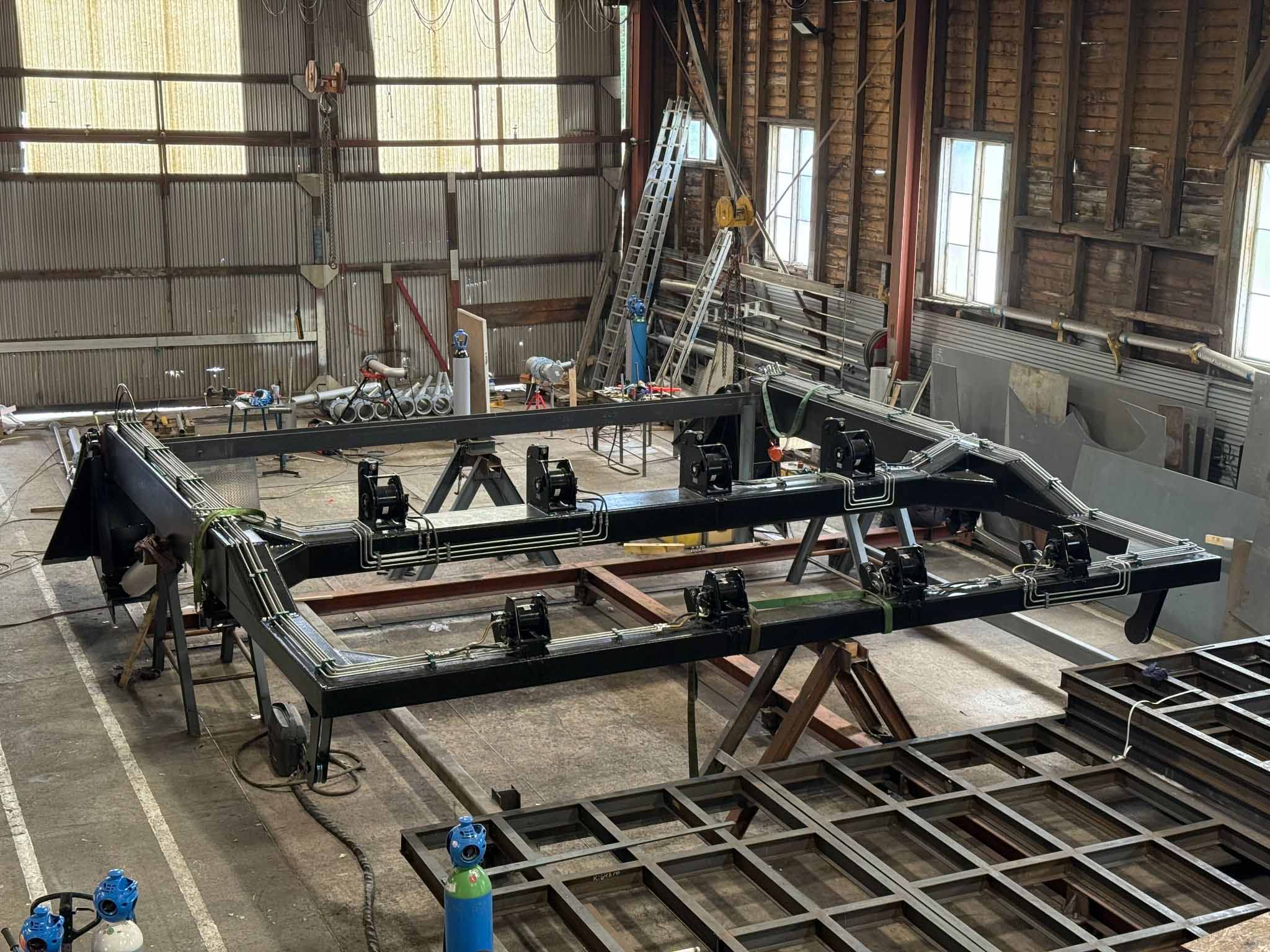 The new A-frame for the wellboat Selma being assembled indoors at the workshop, surrounded by tools.