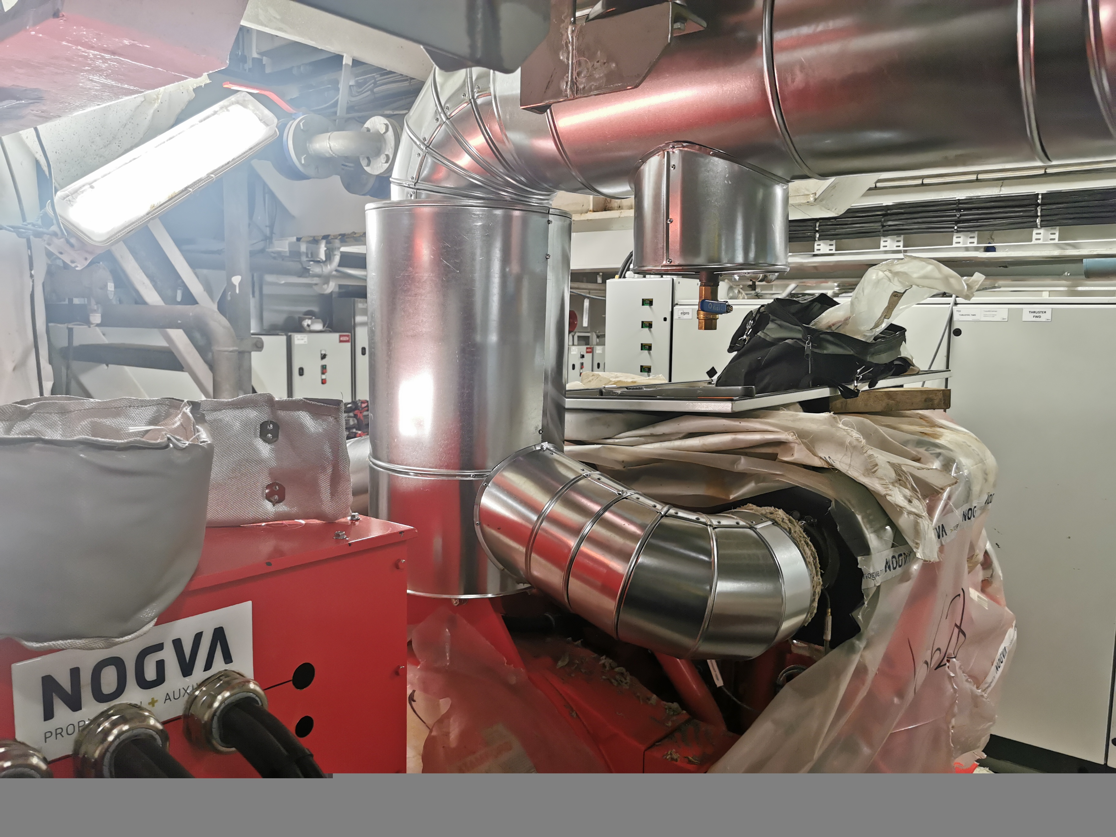 Engine room on the wellboat Selma with two large red diesel generators and technical installations