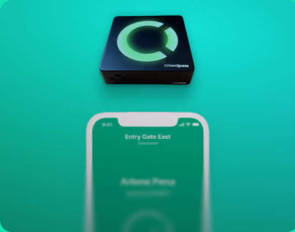 Small black electronic device with a glowing green circular logo and the word crowdpass, above a blurred smartphone screen displaying 'Entry Gate East' on a green background.