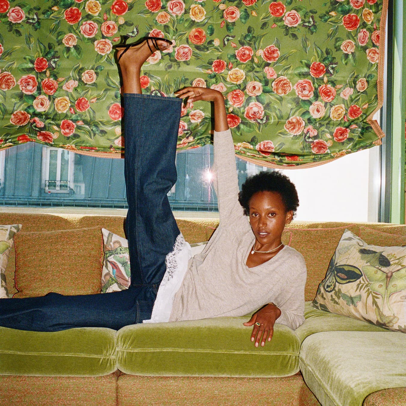 Model posing on a sofa