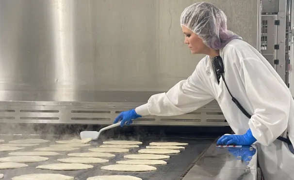 a factory worker making fresh grocery products