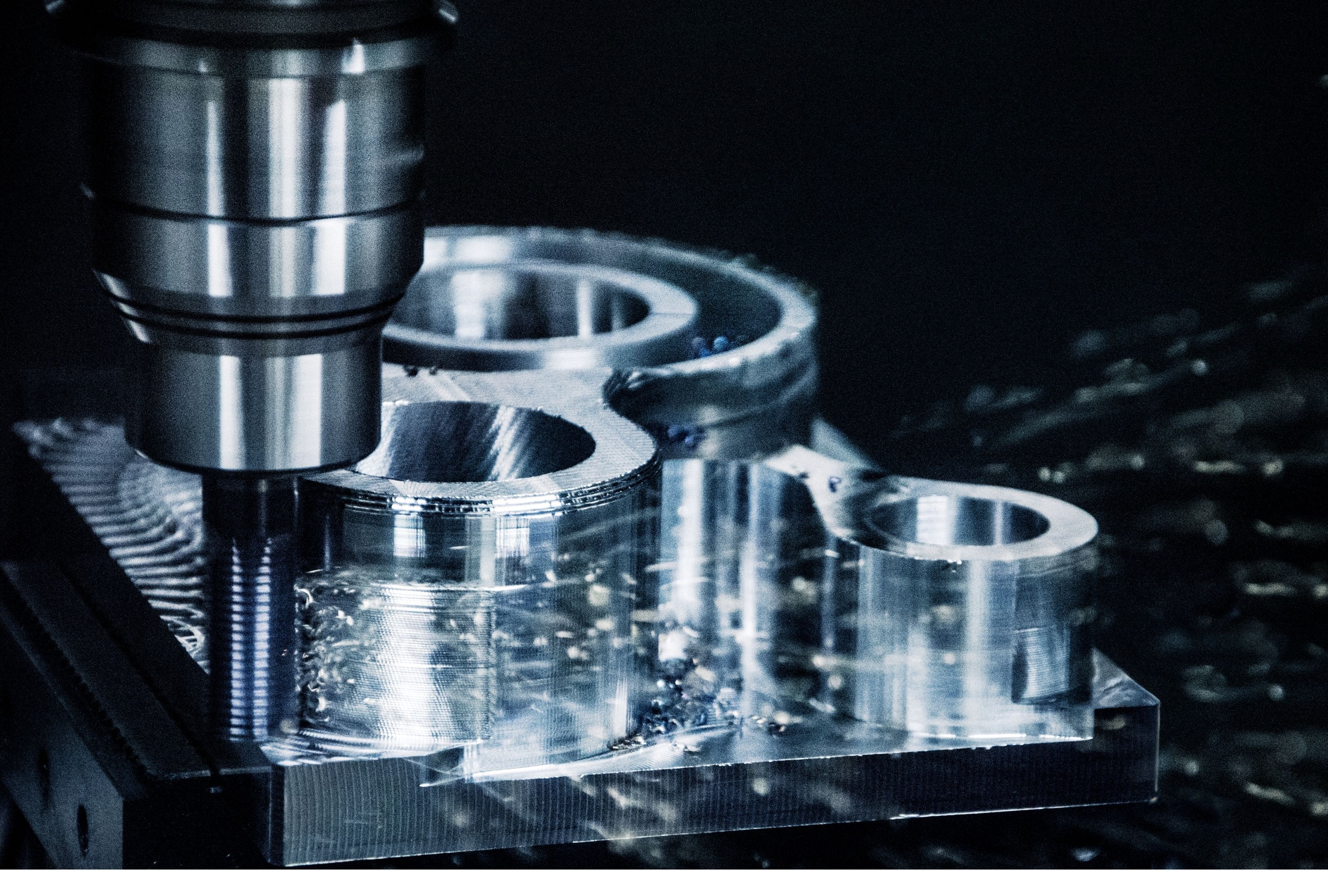 CNC machine cutting a metal workpiece with sparks flying