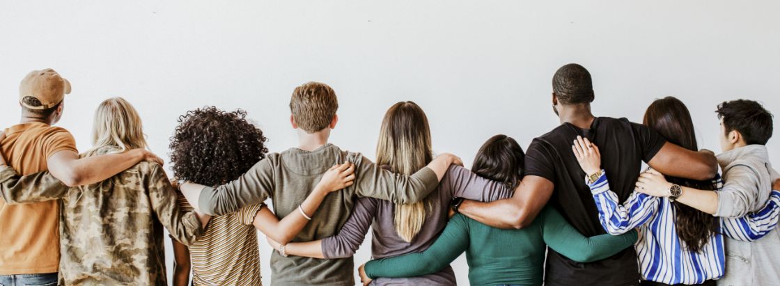 Employees standing in a line with arms around each other